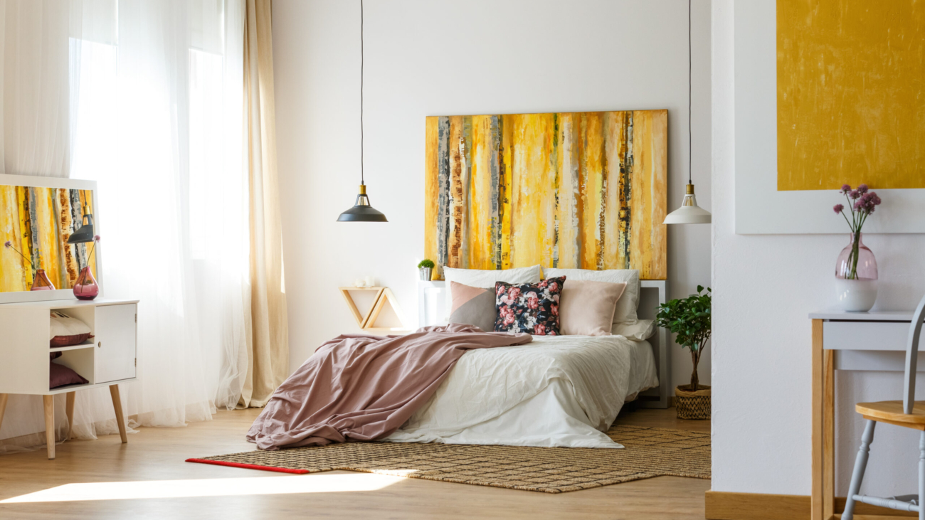 Spacious warm bedroom with contemporary artworks on the walls