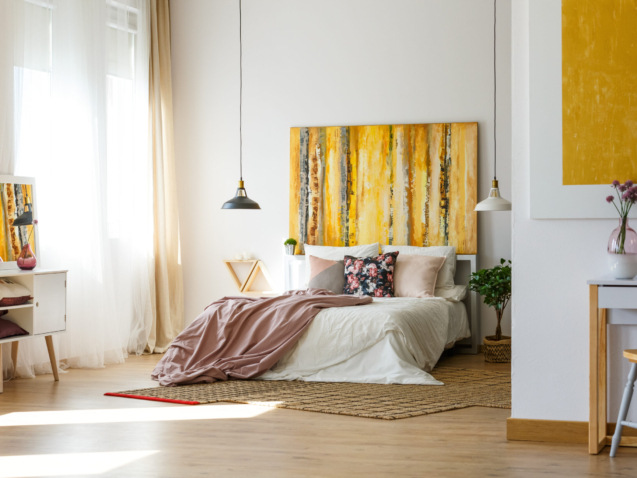 Spacious warm bedroom with contemporary artworks on the walls